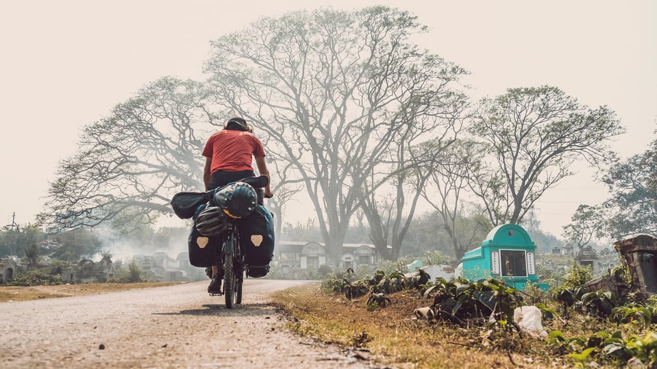 Asian tour by bike. Young man climbing