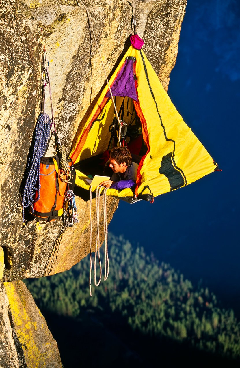 Rock climber bivouaced in a portaledge.