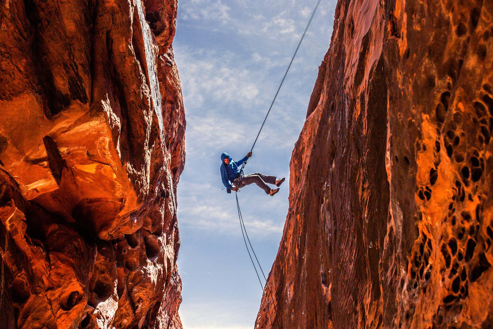 Rock Climber Rappelling into a Slot Canyon