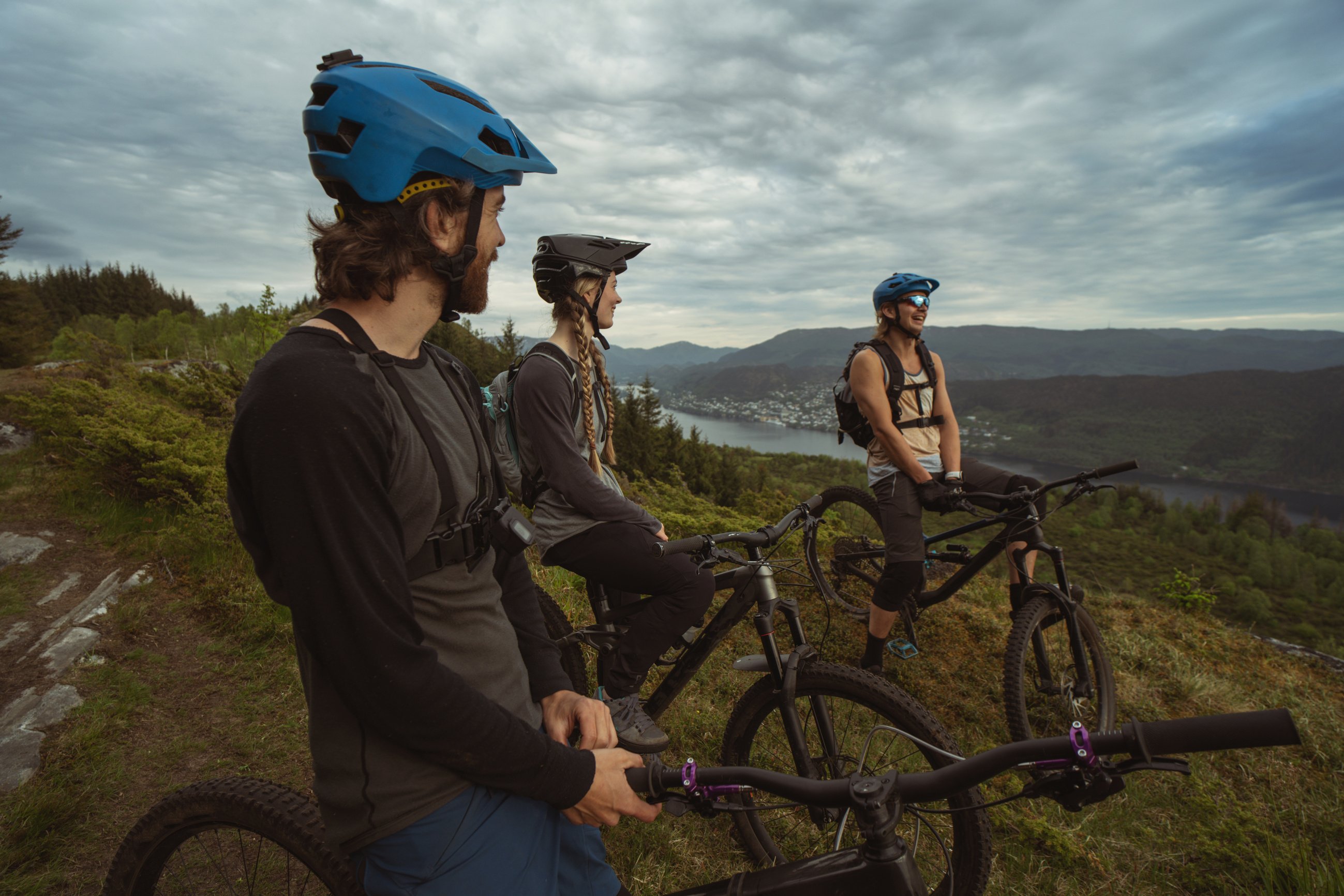 Group of friends mountainbike riders: MTB biking outdoor up mountain of Norway